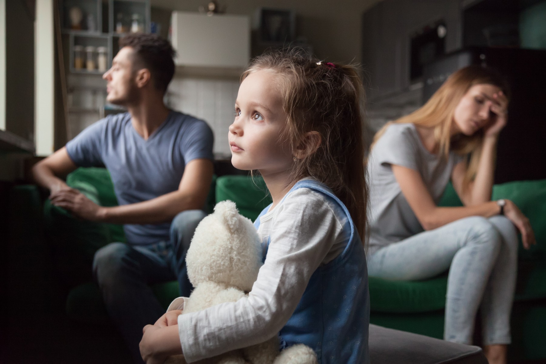 Upset, frustrated little girl tired of parents fight